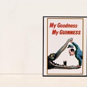 Puede incluir: Un cartel vintage que anuncia la cerveza Guinness. El cartel presenta un cocodrilo de dibujos animados con un hombre que alcanza su boca abierta para tomar un vaso de Guinness. El texto del cartel dice "My Goodness My Guinness".