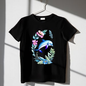 May include: Black t-shirt with a watercolor design of a dolphin jumping through a wreath of flowers.