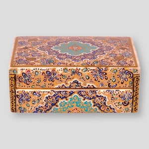 May include: A decorative wooden box with a hinged lid. The box is painted with intricate floral patterns in shades of gold, blue, green, and white.
