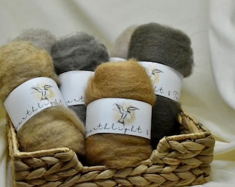 May include: Five skeins of wool yarn in a wicker basket. The yarn is in shades of brown, gray, and beige. The labels on the yarn skeins read "earthlight art".