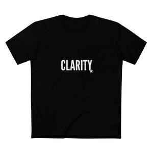 May include: Black t-shirt featuring the word "CLARITY" in white, with a white star. The tee has a crew neck and short sleeves, ideal for everyday wear.