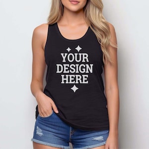 May include: A black sleeveless tank top featuring the white text YOUR DESIGN HERE centered on the chest, accented by four-pointed star icons above and below the text, paired with blue denim shorts with distressed detailing on the front.