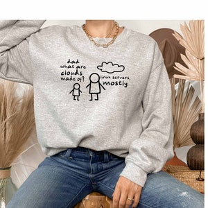 May include: Grey sweatshirt with a humorous illustration of a stick figure asking "Dad, what are clouds made of?" and another stick figure answering "Linux servers, mostly."