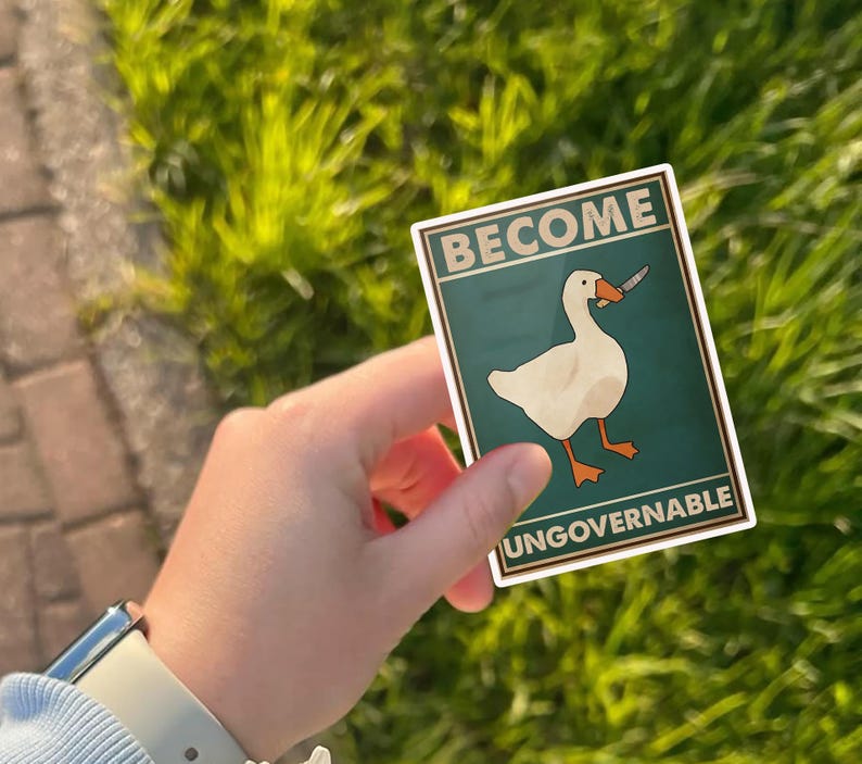 May include: A sticker featuring a white goose holding a knife, with the words "BECOME UNGOVERNABLE" in a rectangular frame. The background is teal, and the goose has orange feet and beak.