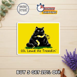 May include: A rectangular sticker featuring a black cat with a yellow sash, sitting on green grass against a yellow background. The text "Oh Lawd He Treadin'" is below the cat. The sticker also has "water proof" and "sameday shipping" text.