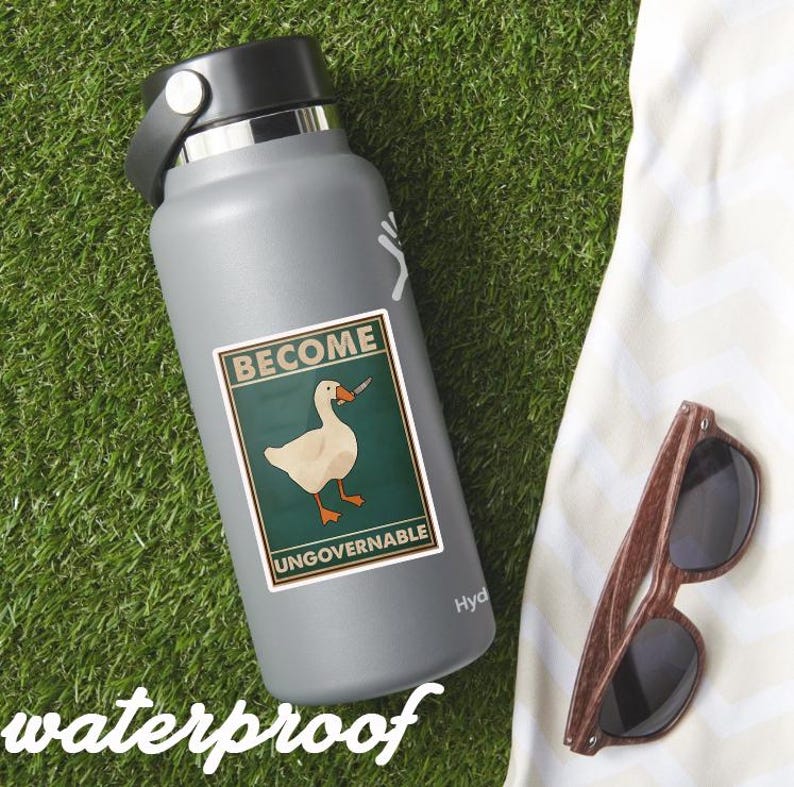 May include: A gray water bottle with a black lid and a sticker that reads "BECOME UNGOVERNABLE" featuring a goose with a knife. The word "waterproof" is printed at the bottom. Wooden-framed sunglasses rest on a white cloth.