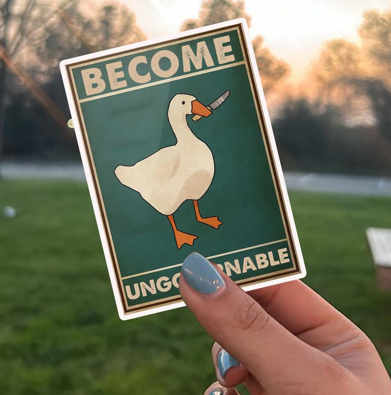 May include: A sticker with a cartoon goose holding a knife. The sticker has the words "BECOME UNGOVERNABLE" in a vintage style font. The goose is white with orange feet and beak, set against a teal background.