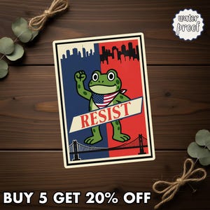 May include: A rectangular sticker featuring a green frog with an American flag bandana, raising a fist. The background is split red and blue with city skylines. The word "RESIST" is displayed. The sticker is waterproof.