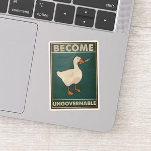 May include: A sticker featuring a white goose holding a knife, set against a teal background. The words "BECOME" and "UNGOVERNABLE" are printed above and below the goose in a vintage style.