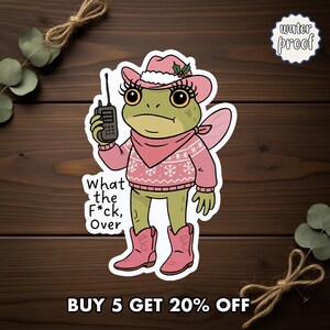 May include: A sticker featuring a cartoon frog wearing a pink cowboy hat, sweater, and boots, holding a walkie-talkie. The text "What the F*ck, Over" is below the frog. The sticker is labeled "water proof".