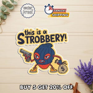 May include: A sticker featuring a cartoon strawberry character wearing a blue ski mask and holding a gun and a money bag. The text "this is a STROBBERY!" is above the character. Additional text includes "water proof" and "SAMEDAY SHIPPING".