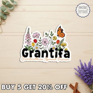 May include: A white sticker with the word "Grantifa" in bold black letters, surrounded by colorful flowers and a butterfly. The text "Grandmothers Against Fascism" is below. The sticker is labeled "water proof".