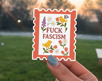 May include: A sticker with a postage stamp design. The stamp is orange with a white center, featuring the text "FUCK FASCISM" and illustrations of yellow birds, flowers, and the number "10¢".