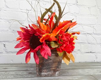 Small flower box with fall themed faux flowers