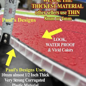 Pu&ograve; includere: Primo piano di un cartello in plastica ondulata rosso e bianco con gocce d'acqua sulla superficie. Il cartello recita "Paul's Designs Uses 10mm almost 1/2 Inch Thick Very Strong Corrugated Plastic Material". Il cartello viene confrontato con un righello, mostrando che &egrave; pi&ugrave; spesso di altri cartelli. Il testo "WE USE THE THICKEST MATERIAL other sellers use THIN 8mm or 4mm" &egrave; anche visibile sul cartello.