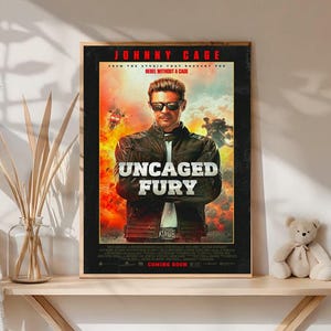 May include: A framed movie poster for "Uncaged Fury" featuring a man in sunglasses and a leather jacket. The poster has a black border with red and yellow accents. The text "Coming Soon" is at the bottom.
