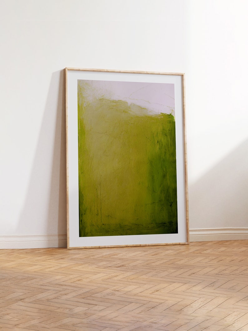 May include: A framed abstract painting with a green and white color scheme. The painting is in a wooden frame and is hanging on a white wall.