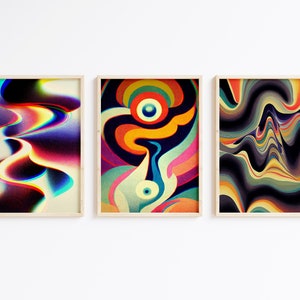 May include: Three framed abstract art prints featuring colourful, swirling patterns. The prints are in wooden frames and are hung on a white wall.