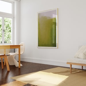 May include: A light brown wooden table with a white chair and a beige rug in a room with a large abstract painting on the wall.