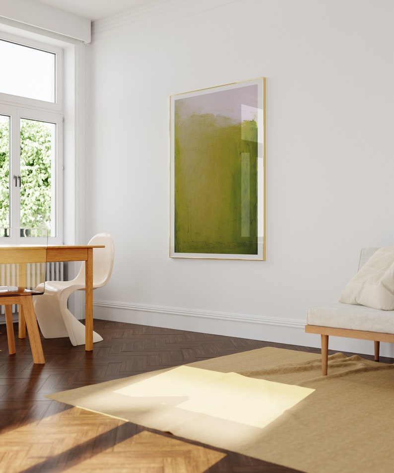 May include: A light brown wooden table with a white chair and a beige rug in a room with a large abstract painting on the wall.