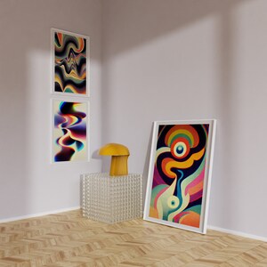 May include: Three abstract art prints in white frames, featuring colourful, swirling patterns. The prints are hung on a white wall, with a yellow mushroom-shaped lamp and a clear glass cube on a wooden floor.