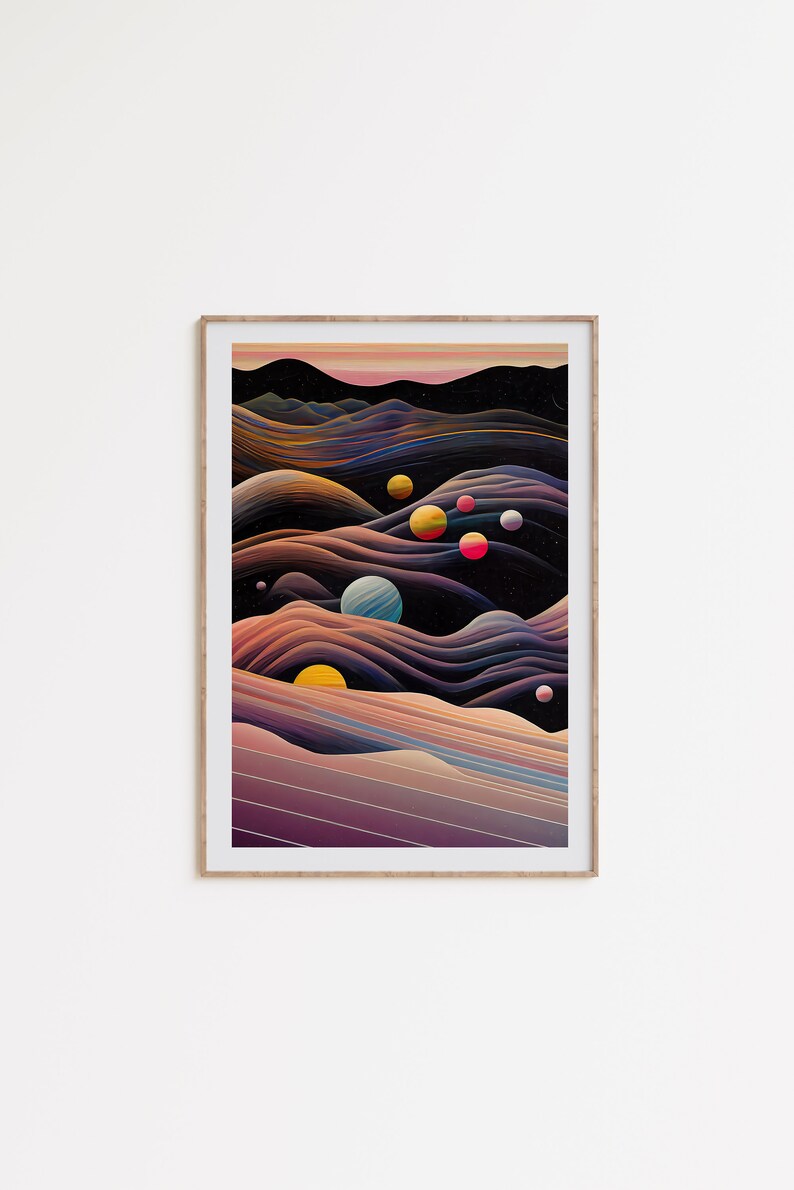 May include: A framed abstract art print with a dark background and colourful planets. The print features a landscape of layered, wavy lines in shades of purple, pink, and blue.