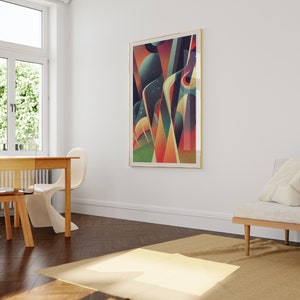 May include: Abstract geometric art print in a gold frame with a colorful design of red, orange, yellow, green, blue, and purple shapes. The print is hanging on a white wall in a room with a wooden floor and a white couch.