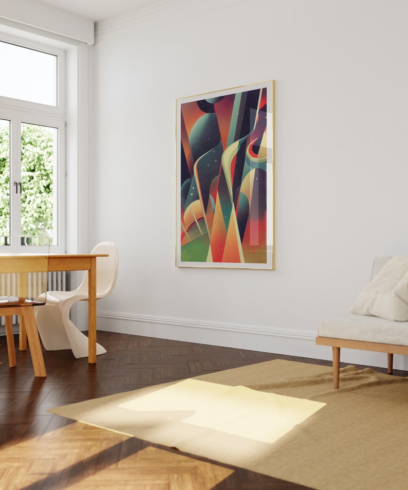 May include: Abstract geometric art print in a gold frame with a colorful design of red, orange, yellow, green, blue, and purple shapes. The print is hanging on a white wall in a room with a wooden floor and a white couch.