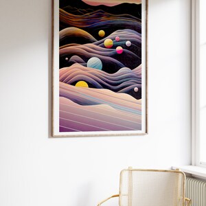 May include: Abstract art print featuring a dark blue background with colourful planets and swirling lines in shades of purple, pink, yellow, and orange. The print is framed in a light wood frame.
