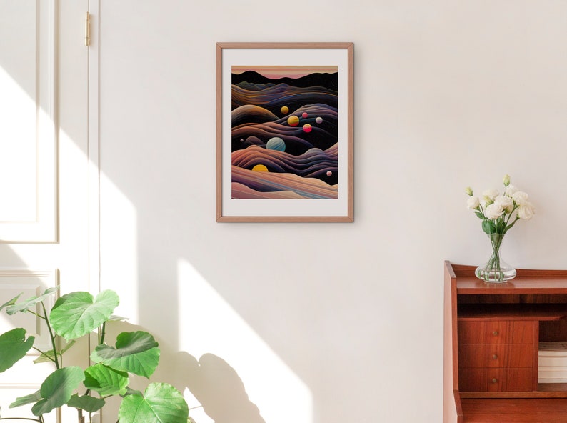 May include: A framed abstract art print with a dark background and colourful, swirling shapes. The print features a series of overlapping, wavy lines in shades of purple, blue, and yellow. There are several small, colourful circles scattered throughout the print.