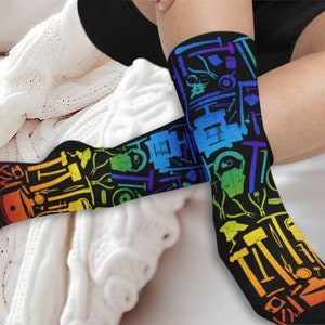 May include: A pair of black socks with a rainbow pattern of various tools. The socks are made of a soft, comfortable material and are perfect for everyday wear.