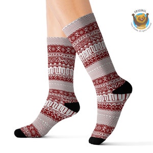 May include: Red and white patterned socks with a geometric design. The socks are shown on a model's legs.