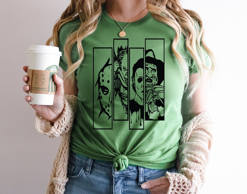 May include: Green t-shirt with a black graphic of four horror movie characters' faces. The characters are Jason Voorhees, Freddy Krueger, Michael Myers, and Leatherface.