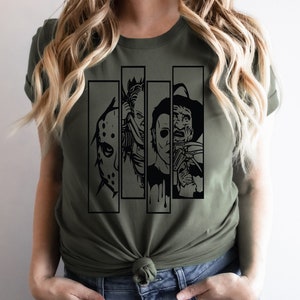 May include: A green t-shirt with a black graphic print of four horror movie characters. The characters are Jason Voorhees, Freddy Krueger, Michael Myers, and Leatherface.