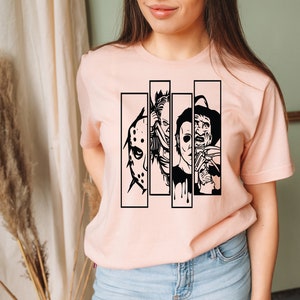 May include: A pink t-shirt with a black graphic of four horror movie characters. The characters are Jason Voorhees, Michael Myers, Freddy Krueger, and Leatherface.