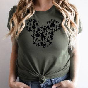 May include: A green t-shirt featuring a black silhouette of Mickey Mouse's head made up of various Disney characters.