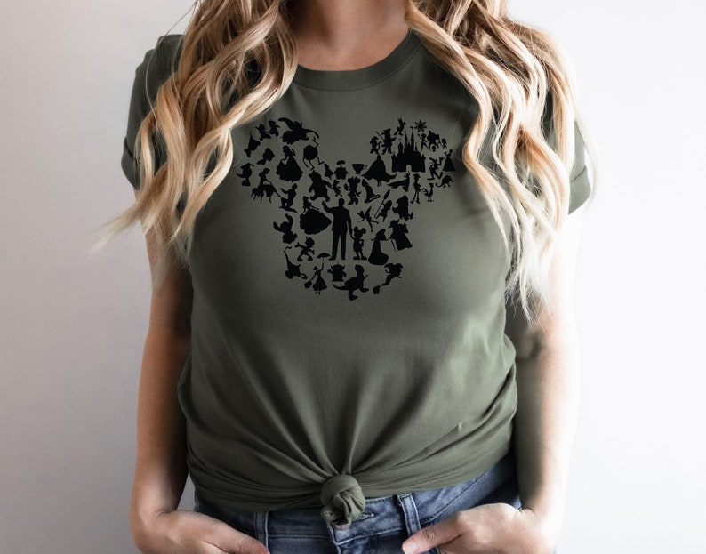 May include: A green t-shirt featuring a black silhouette of Mickey Mouse's head made up of various Disney characters.