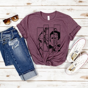 May include: A maroon t-shirt with a black graphic of four horror movie characters. The characters are Jason Voorhees, Freddy Krueger, Michael Myers, and Leatherface. The graphic is in a comic book style.