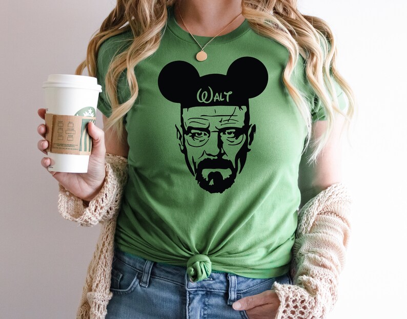 May include: Green t-shirt with a black silhouette of Walter White from Breaking Bad wearing Mickey Mouse ears with the text "Walt" on the headband.