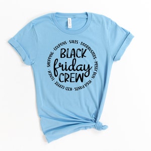 May include: Light blue t-shirt with a black circle graphic that says "Black Friday Crew" with a list of activities around the circle.