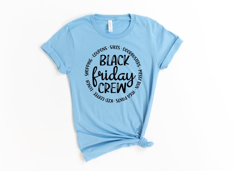 May include: Light blue t-shirt with a black circle graphic that says "Black Friday Crew" with a list of activities around the circle.