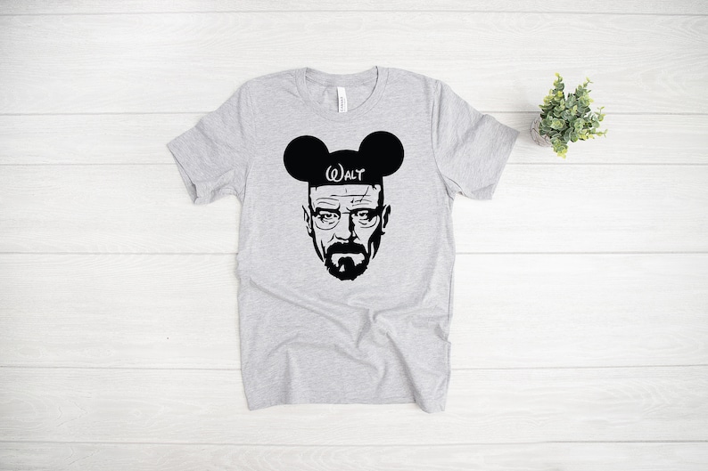 May include: A gray t-shirt with a black and white image of Walter White from the TV show Breaking Bad wearing Mickey Mouse ears with the word "WALT" on the headband.