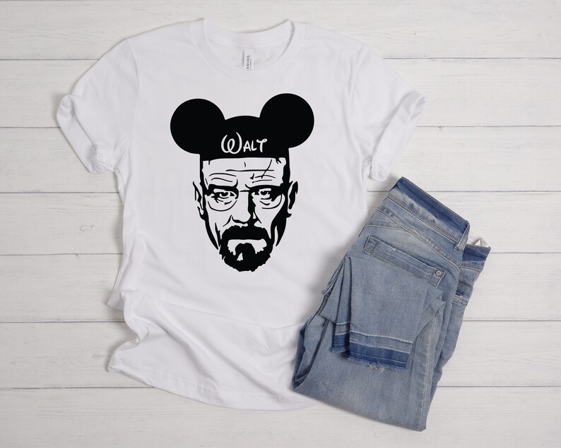 May include: White t-shirt with a black silhouette of Walter White from Breaking Bad wearing Mickey Mouse ears with the text "WALT" on the headband.