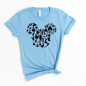 May include: A light blue t-shirt featuring a black silhouette of Mickey Mouse's head formed from various Disney characters.
