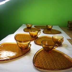 Vintage Anchor Hocking amber glass daisy and button design luncheon snack plates with cups six sets and one extra plate.