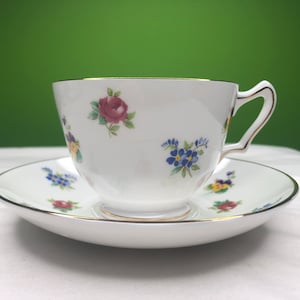 Vintage Staffordshire Crown Fine Bone China Tea Cup and Saucer with gorgeous Rose and pansy pattern along with gold trim made in England