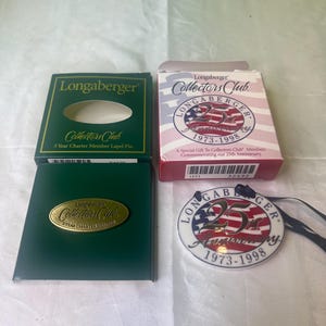 May include: Three boxes and a round ceramic ornament featuring the Longaberger Collectors Club logo. The boxes are green, red, and white. The ornament is white with red, white, and blue stripes and the text "Longaberger 25th Anniversary 1973-1998".