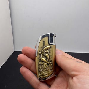 Vintage Metal Lighter with Gold Colored Embossed Dolphin Design ~ Slim ~ Works!