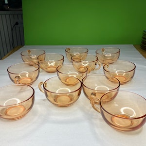 Vintage Tangerine Glass Cup and Saucer set.  10 sets available