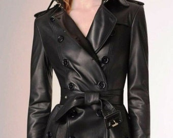 May include: A black leather trench coat with a double-breasted closure, a belt, and a classic collar.